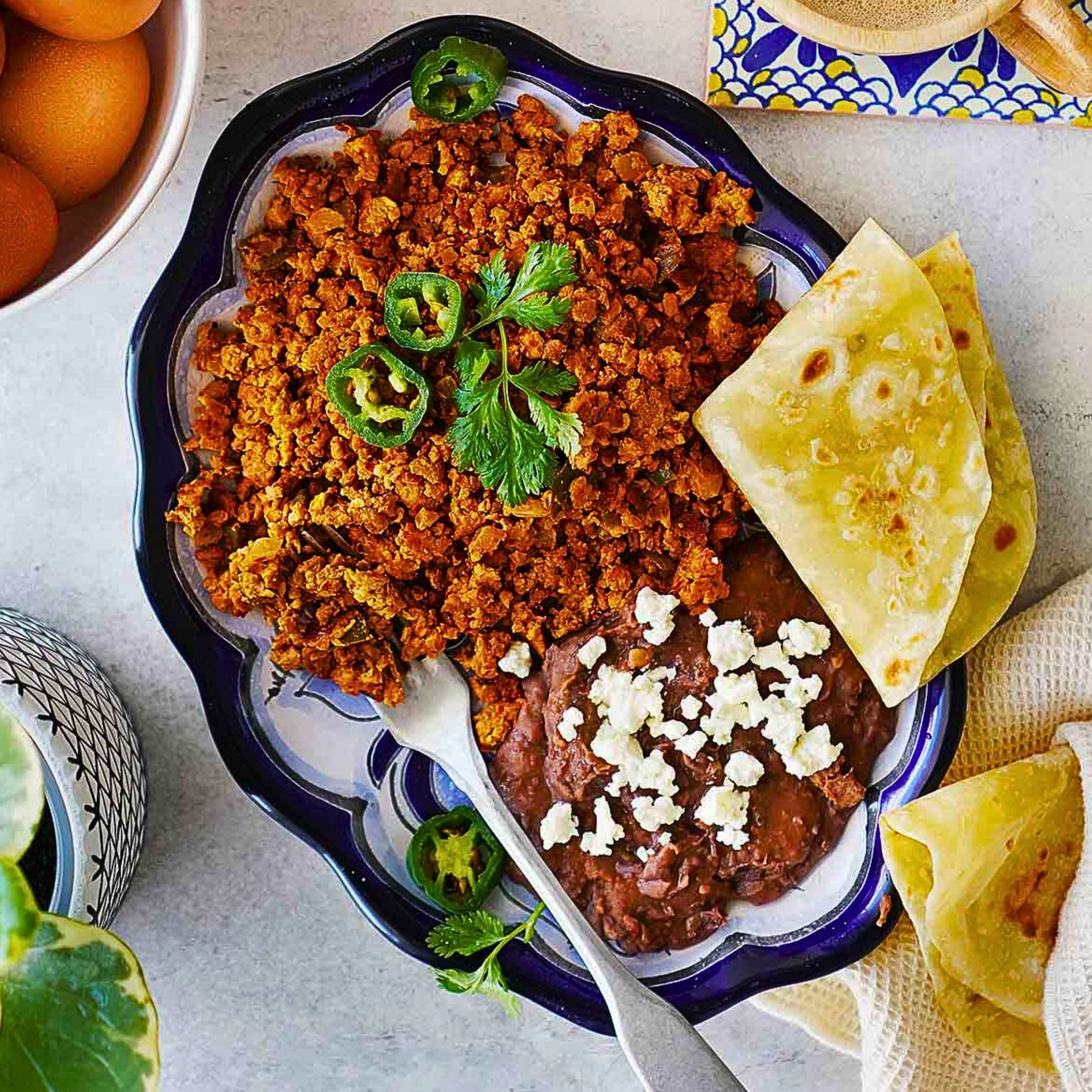 Huevos con Chorizo (Refried beans, Spanish rice & Tortillas)