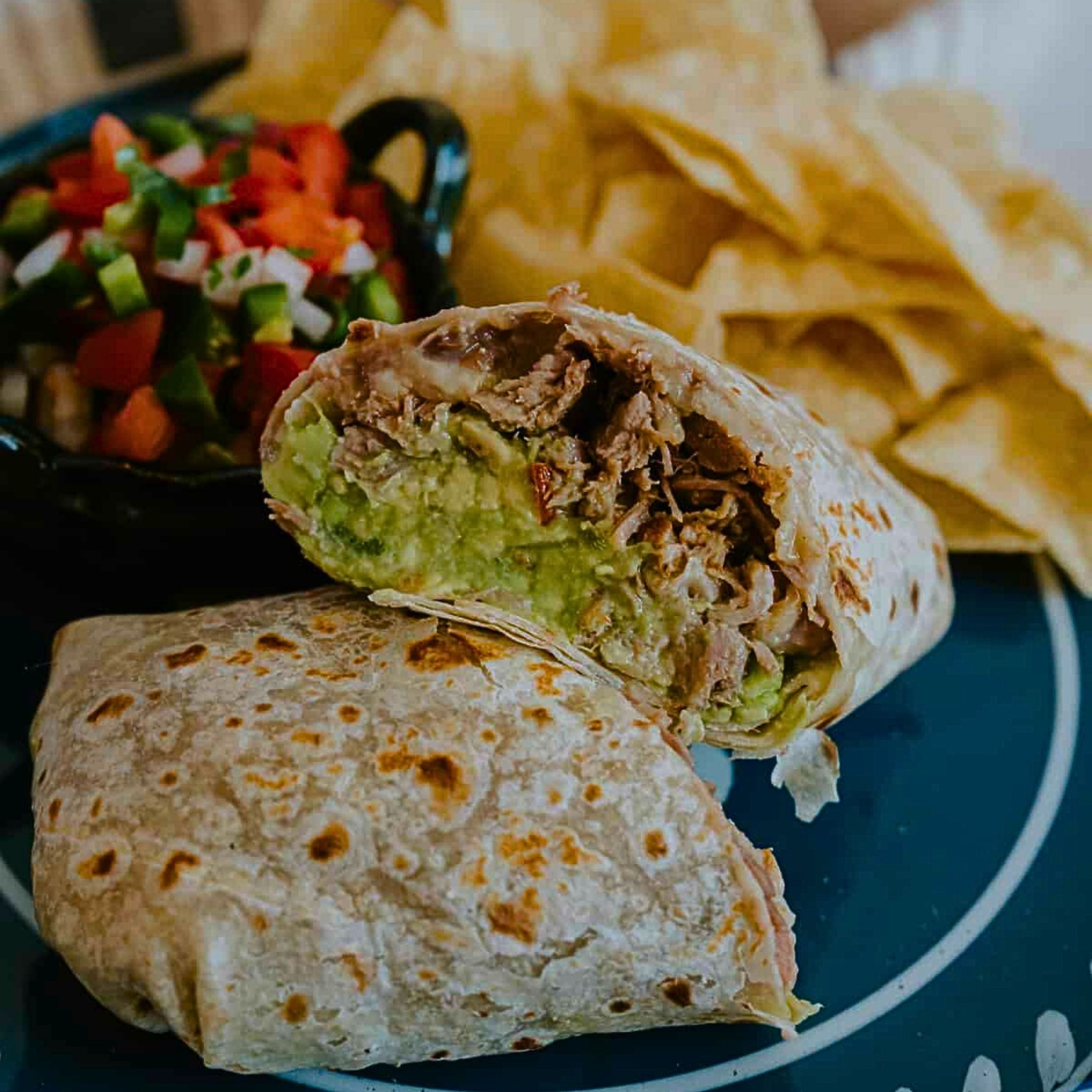 Super Burrito- (Carnitas - Plus sour cream, guacamole and cheese)